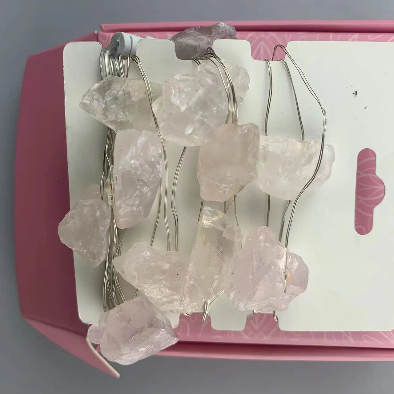 "Rose Quartz Crystal Lights in open pink box showing rose pink crystals on card wrap and USB plug on white background"
