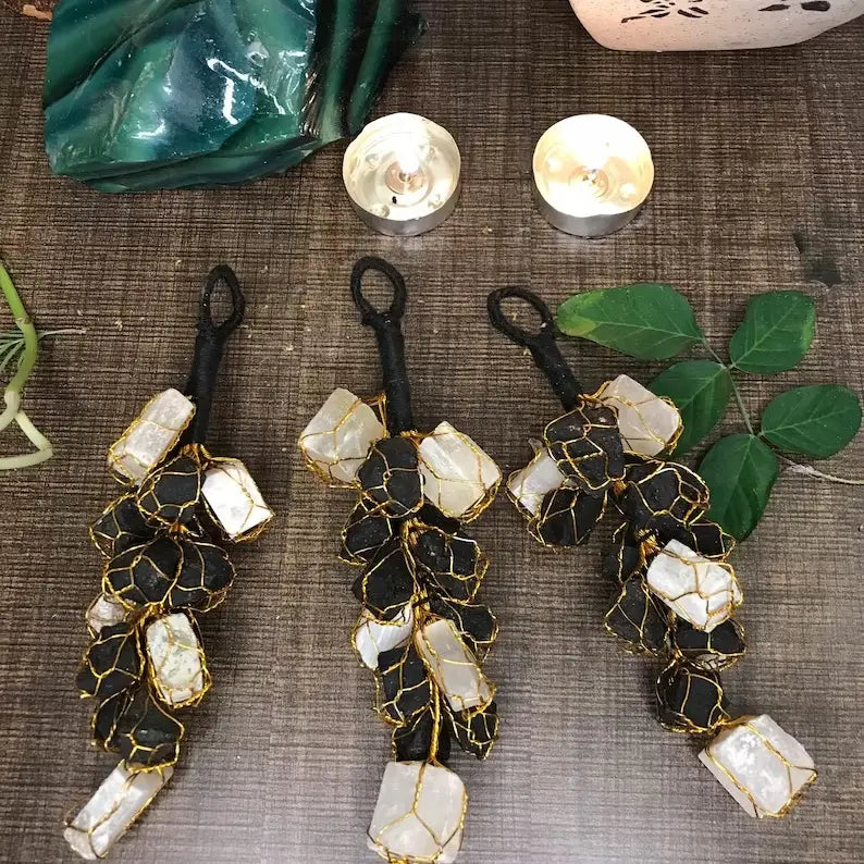 rough black tourmaline and selenite  crystals, gold wire wrapped like a bunch of grapes with a black cord stem