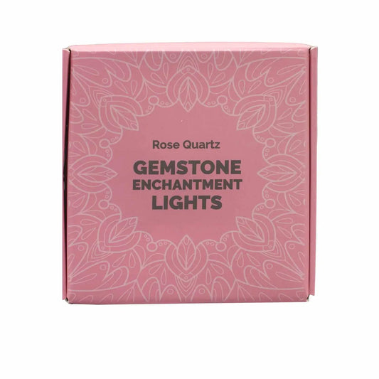 "Rose Quartz Crystal Lights pink square box with white lace design and black writing on white background"