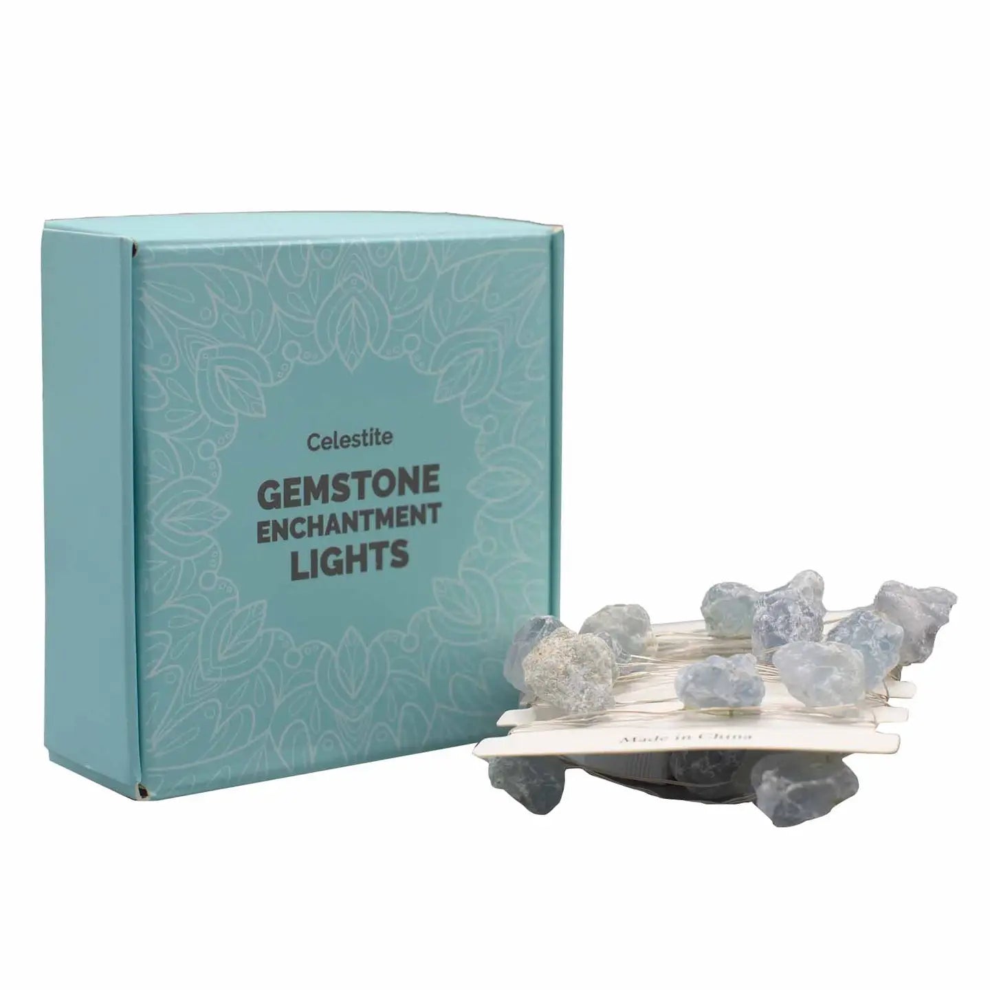 "Celestite Crystal Lights on card wrap in front of ice blue box on white background"