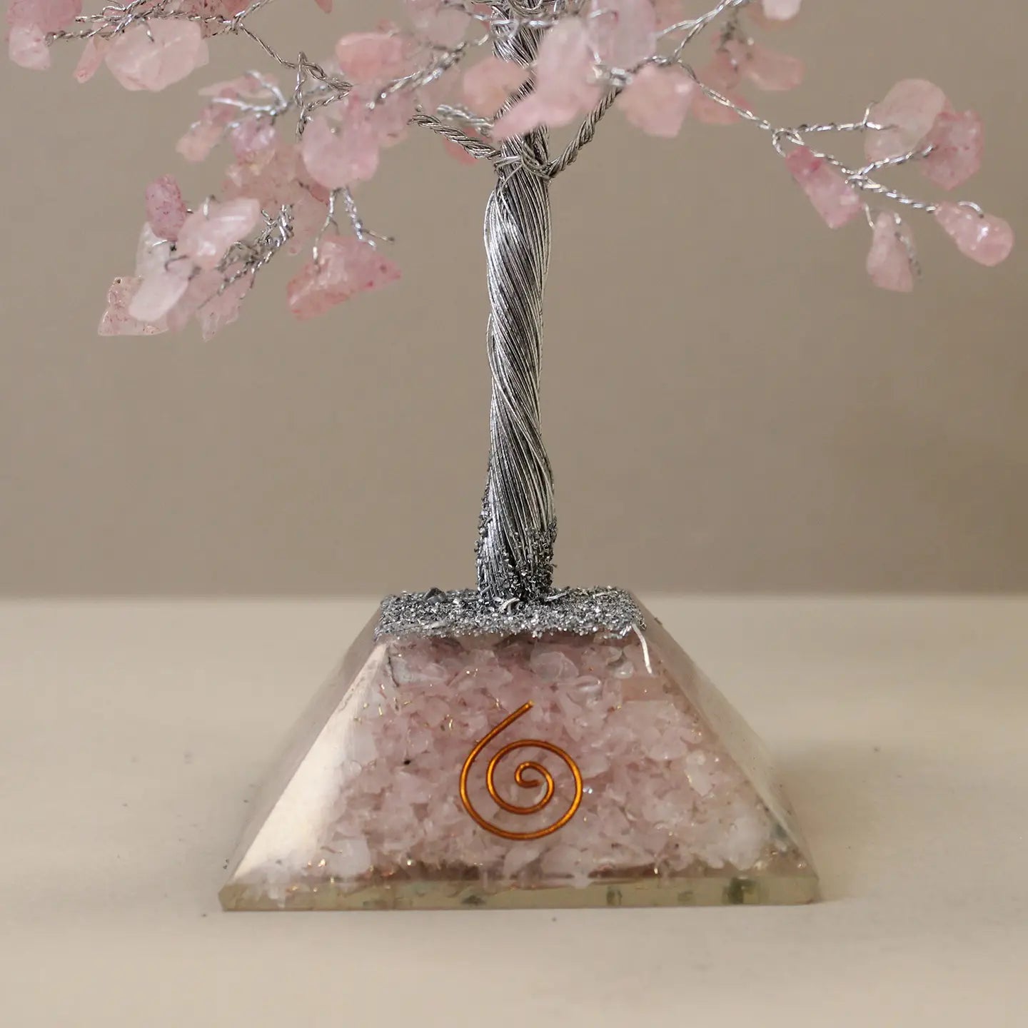 "Close up of Rose Quartz Crystal Tree orgonite resin base with rose quartz crystals and gold spiral"