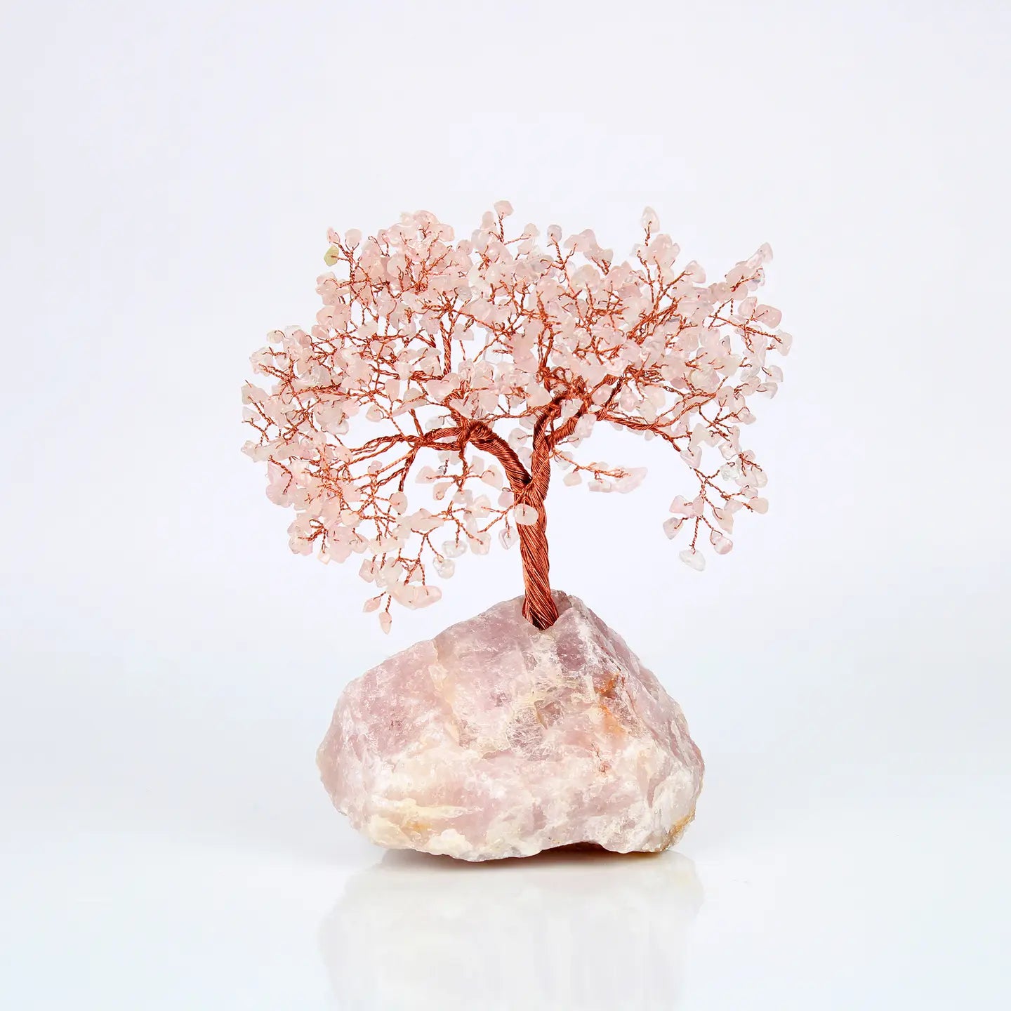"Rose Quartz Crystal Tree with 500 beads on copper wire branches in natural rose quartz base on white background"