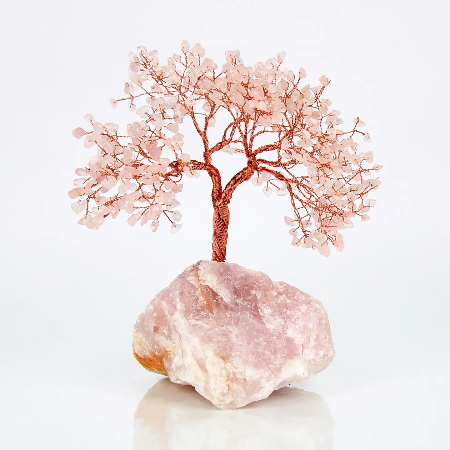 "Rose Quartz Crystal Tree with 500 beads on copper wire branches in natural rose quartz base on white background"